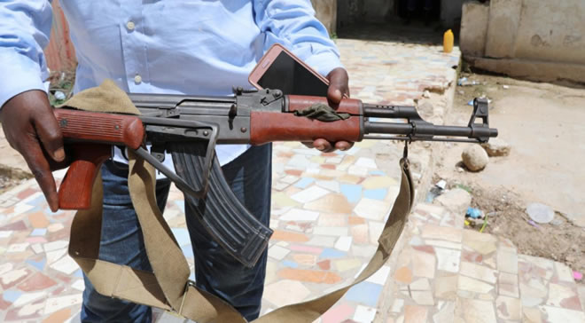 A Somali Dealer holds a weapon looted from a former United Arab Emirates (UAE) military training camp during a Reuters interview in Mogadishu, Somalia April 25, 2018. Reuters/Feisal Omar
